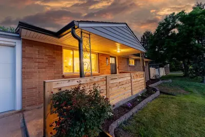 a house with a wooden fence in a yard at Arvada Hotspot Modern Vibes Sauna and Games in Arvada