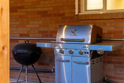 a grill with a pan and a bbq at Arvada Hotspot Modern Vibes Sauna and Games in Arvada
