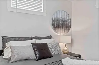a bedroom with a bed and a mirror on the wall at The Urban Roost I A Rustic City Escape in Denver