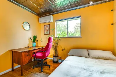 a bedroom with a desk and a bed and a chair at Less Than 1 Mi to CU Boulder Home with Fenced Yard! in Boulder