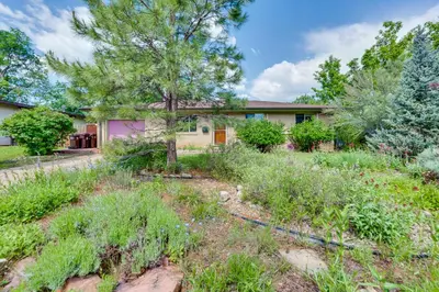 an empty yard in front of a house at Less Than 1 Mi to CU Boulder Home with Fenced Yard! in Boulder
