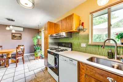 a kitchen with a sink and a stove top oven at Less Than 1 Mi to CU Boulder Home with Fenced Yard! in Boulder