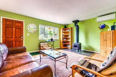 a living room with a couch and a glass table at Less Than 1 Mi to CU Boulder Home with Fenced Yard! in Boulder