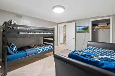 a bedroom with two bunk beds in a room at Central Huge Duplex - Sleeps 16 in Wheat Ridge