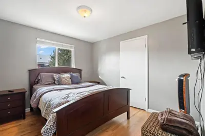 a bedroom with a bed and a window at Central Huge Duplex - Sleeps 16 in Wheat Ridge