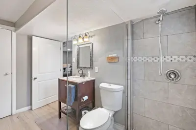 a bathroom with a toilet and a shower at Central Huge Duplex - Sleeps 16 in Wheat Ridge