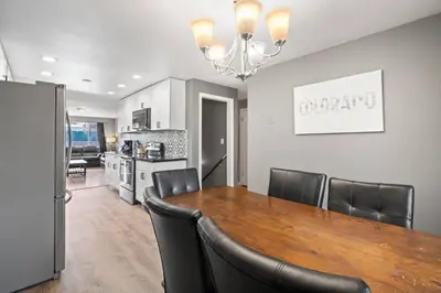 a dining room and kitchen with a table and chairs at Central Huge Duplex - Sleeps 16 in Wheat Ridge