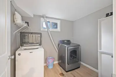 a laundry room with a washer and dryer and a refrigerator at Central Huge Duplex - Sleeps 16 in Wheat Ridge