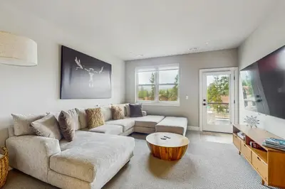 a living room with a couch and a coffee table at Modern Mountain View in Fraser