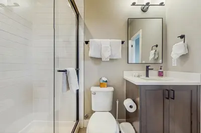 a bathroom with a toilet and a sink and a shower at Modern Mountain View in Fraser