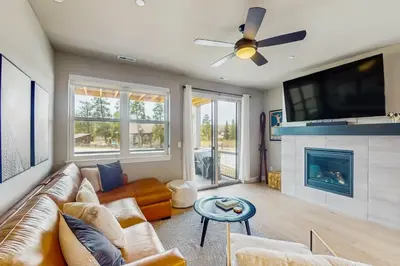 a living room with a couch and a fireplace at Modern Mountain View in Fraser