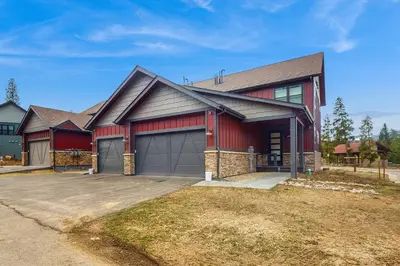 a red house with a garage at Modern Mountain View in Fraser