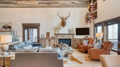 a living room filled with furniture and a fireplace at Winterhaven Estate by AvantStay Sleeps 19 Guests Mountain Compound w Views Firepit Hot Tub in Winter Park