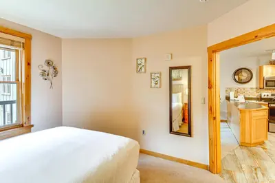 a bedroom with a white bed and a mirror at On-Site Gondola Access Keystone Ski Condo in Keystone