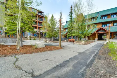 a sidewalk in front of a building with trees at On-Site Gondola Access Keystone Ski Condo in Keystone