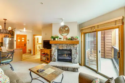 a living room with a fireplace and a kitchen at On-Site Gondola Access Keystone Ski Condo in Keystone