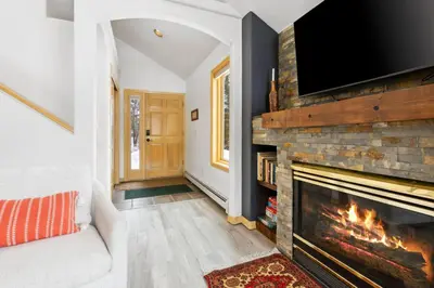 a living room with a fireplace and a flat screen tv at Charming Frisco Getaway. Close to Main St. Sleeps 8 in Frisco