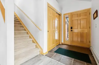a hallway with stairs and a wooden door at Charming Frisco Getaway. Close to Main St. Sleeps 8 in Frisco