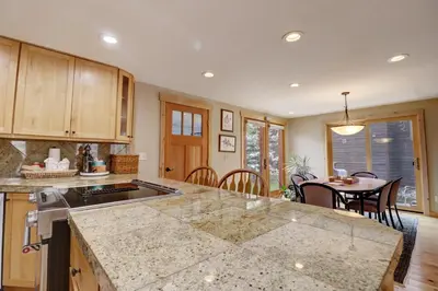 a kitchen with a counter top and a dining room at 1250 Willow Grove townhouse in Silverthorne