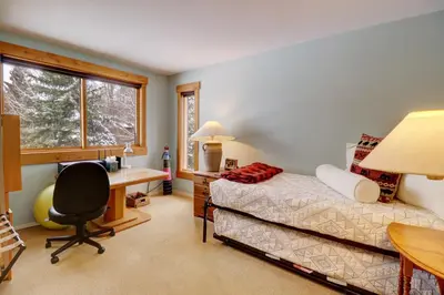 a bedroom with a desk and a bed and a desk and chair at 1250 Willow Grove townhouse in Silverthorne