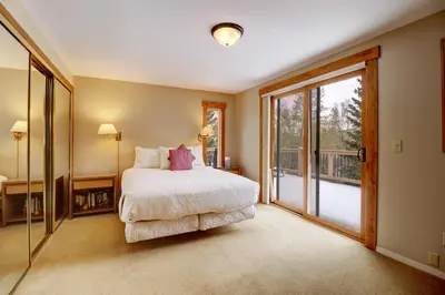 a bedroom with a bed and a sliding glass door at 1250 Willow Grove townhouse in Silverthorne