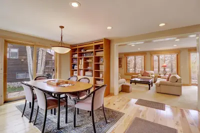 a dining room and living room with a table and chairs at 1250 Willow Grove townhouse in Silverthorne