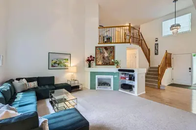 a living room with a couch and a fireplace at Sleeps 9 - Family Retreat - Scenic Trails - Views in Erie
