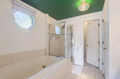 a bathroom with a tub and a shower and a window at Sleeps 9 - Family Retreat - Scenic Trails - Views in Erie