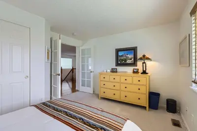 a bedroom with a bed and a yellow dresser at Sleeps 9 - Family Retreat - Scenic Trails - Views in Erie