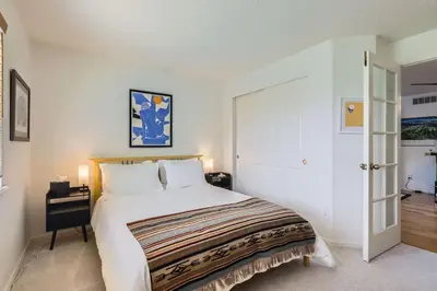 a bedroom with a large white bed and a desk at Sleeps 9 - Family Retreat - Scenic Trails - Views in Erie