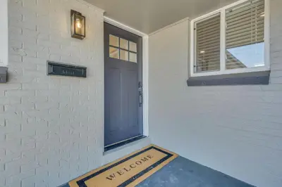 a door with a welcome sign in front of a house at Vacation Launch Pad - Great for Groups in Arvada