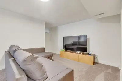 a living room with a couch and a flat screen tv at Vacation Launch Pad - Great for Groups in Arvada