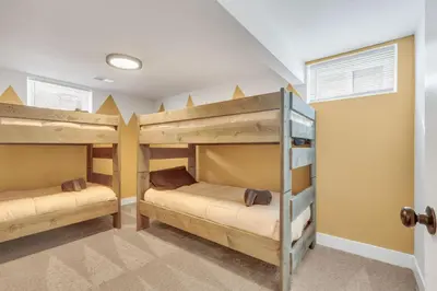 two bunk beds in a room with a hallway at Vacation Launch Pad - Great for Groups in Arvada