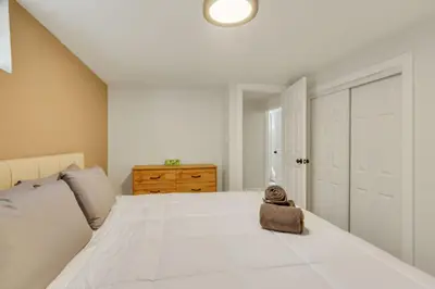 a bedroom with a large white bed with a stuffed animal on it at Vacation Launch Pad - Great for Groups in Arvada
