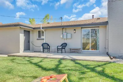 a house with two chairs and a table in the yard at Vacation Launch Pad - Great for Groups in Arvada
