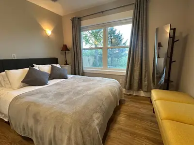 a bedroom with a large bed and a window at Entire Private Garden-Level Retreat in Englewood