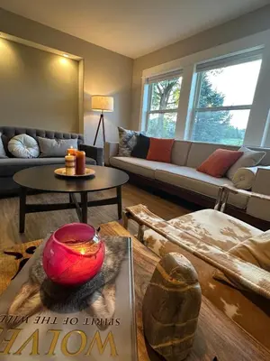 a living room with a couch and a table at Entire Private Garden-Level Retreat in Englewood