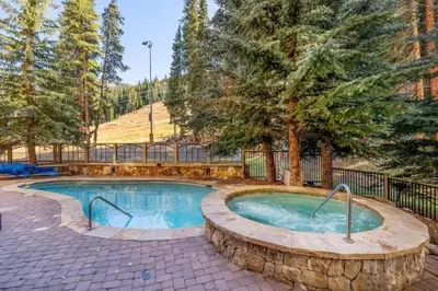 a swimming pool in a yard with trees at Lone Eagle 3013 condo in Keystone