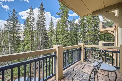 a balcony with a table and chairs and a view of the mountains at Lone Eagle 3013 condo in Keystone