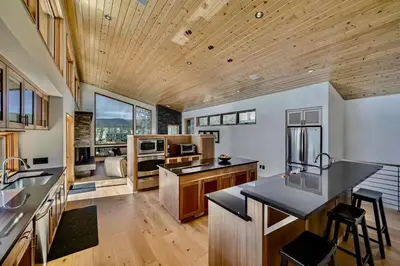 a large kitchen with wooden ceilings and wooden counters at Caribou Ridge with Hot Tub! Pet Friendly with James Peak Views - Sleeps 10 in Nederland