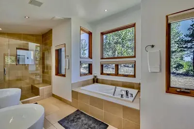 a bathroom with a tub and a toilet and a sink at Caribou Ridge with Hot Tub! Pet Friendly with James Peak Views - Sleeps 10 in Nederland