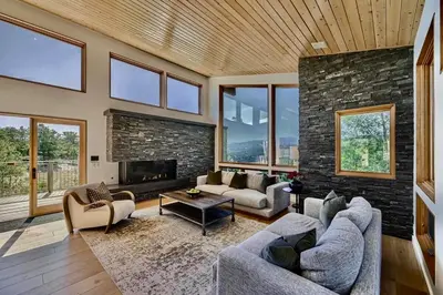 a living room with two couches and a fireplace at Caribou Ridge with Hot Tub! Pet Friendly with James Peak Views - Sleeps 10 in Nederland