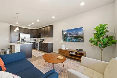 a living room with a couch and a table at Northfield Hideaway, King Suite, EV, Pet-Friendly in Fort Collins