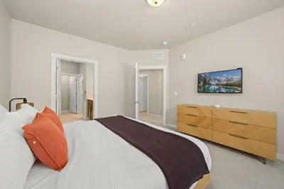 a bedroom with a large bed and a wooden dresser at Northfield Hideaway, King Suite, EV, Pet-Friendly in Fort Collins