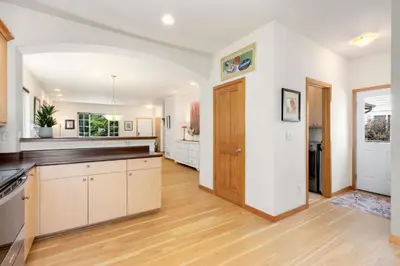 an empty kitchen with white walls and wooden floors at Rigden Retreat Garage, Dog Friendly, Near Trails in Fort Collins