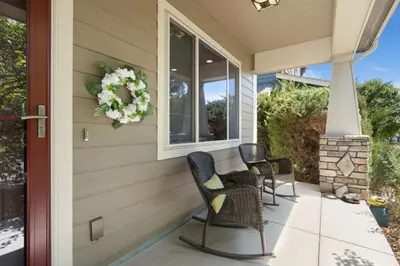 a porch with chairs and a wreath on a house at Rigden Retreat Garage, Dog Friendly, Near Trails in Fort Collins