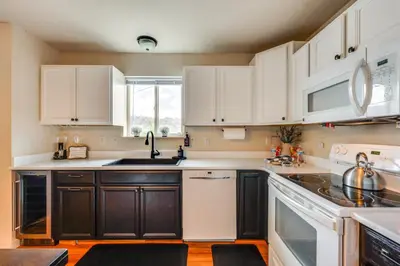 a kitchen with black and white cabinets and a sink at 1 Mi to Dtwn Estes Park Mtn-View Haven! in Estes Park