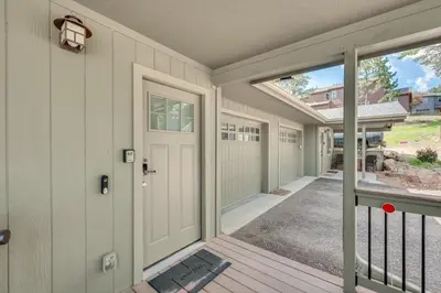 a front door of a home with a porch at 1 Mi to Dtwn Estes Park Mtn-View Haven! in Estes Park