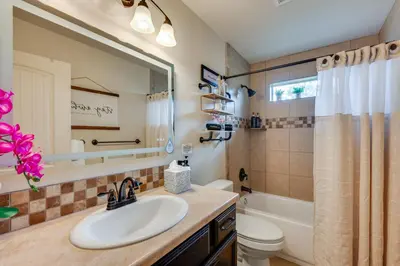 a bathroom with a sink and a toilet and a mirror at 1 Mi to Dtwn Estes Park Mtn-View Haven! in Estes Park
