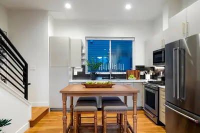 a kitchen with a wooden table with chairs and a refrigerator at Million Dollar Rooftop MTN Views -2 King Beds-DT Golden in Golden